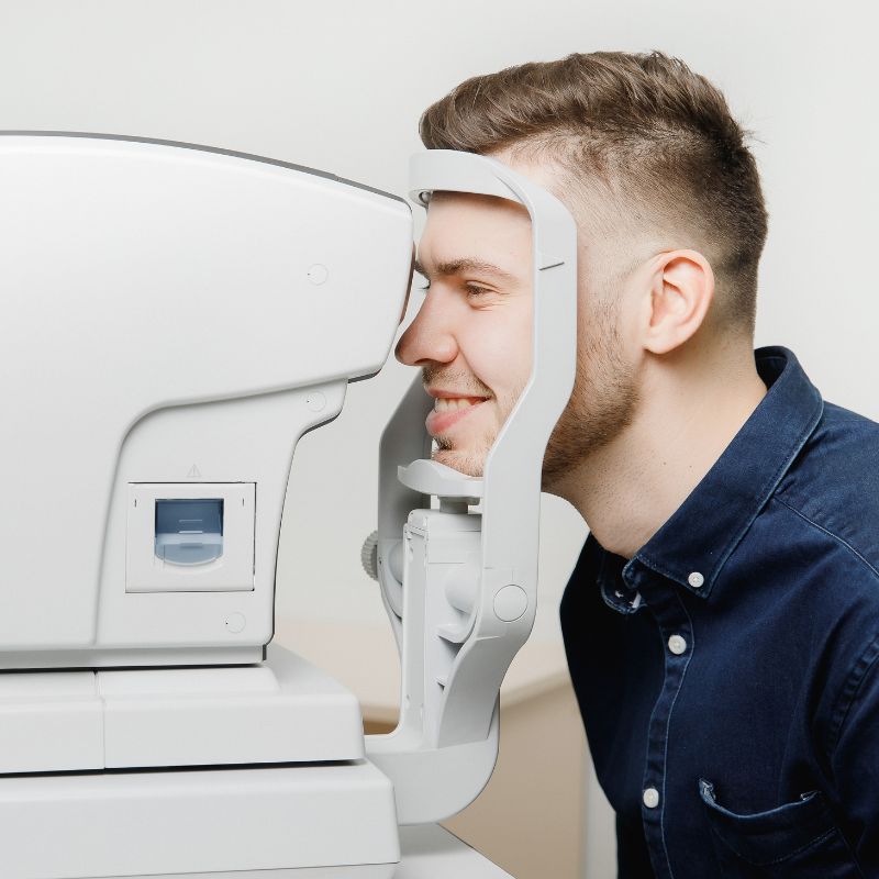 young smiling man getting an eye exam